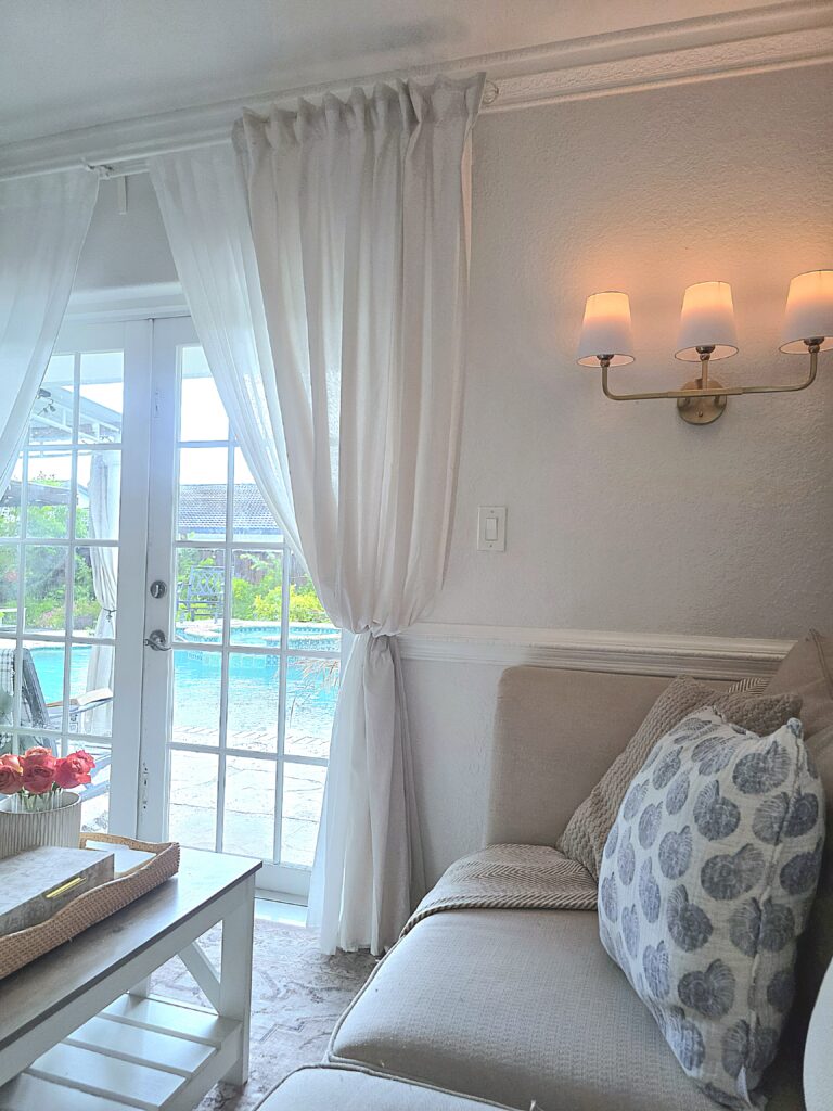 Linen curtains hung up high on wall