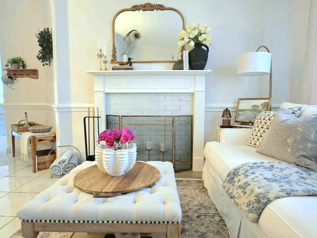 Living room square ottoman with a faux fireplace and large mirror