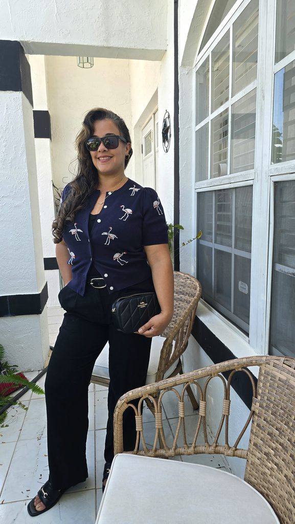 Navy flamingo cardigan styled with black pants, sandals and a black crossbody bag for fall in Miami.
